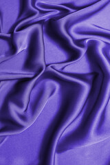 Blue silk or satin luxury fabric texture. Top view.