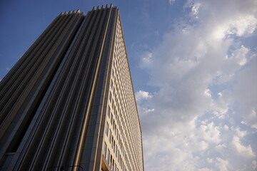 Fototapeta premium high rise apartment building against the sky against a bright blue sky background