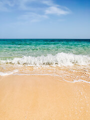 Sea shore sand beach landscape with blue sky background on sun summer day. Ocean vacation concept. Digital detox, isolation on tropical island. White sailboat on wave. Calm, tranquil state of mind.