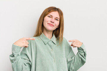 red head pretty woman looking proud, arrogant, happy, surprised and satisfied, pointing to self,...