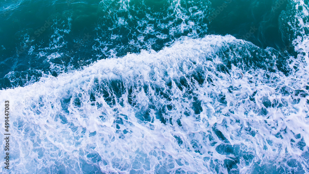 Aufkleber top view with waves and bubbles of ocean blue water surface.