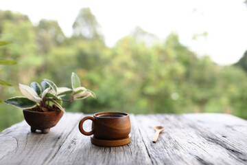 Obraz na płótnie Canvas Wooden coffee cup and hoya tree plant
