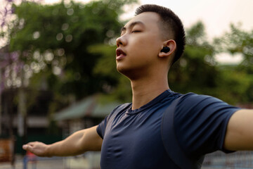 Sports and recreation concept a male adolescent doing warm-up movements as raising his body temperature and increasing blood flow to his muscles