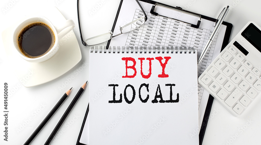 Poster buy local text on the paper with calculator, notepad, coffee ,pen with graph