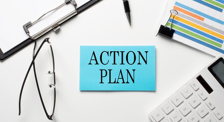 Stickers with chart,calculator and paper with text ACTION PLAN on the white background