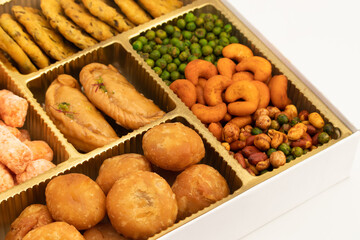 Indian Shahi Mithai Gujia Or Gujiya, Spicy Crispy Snacks Namkeen Also Called Nimki, Mathri, Matar, Kachori, Mixture Decorated in Giftbox. Food Theme For Holi, Deepawali, Rakshabandhan, Dussehra, Rakhi