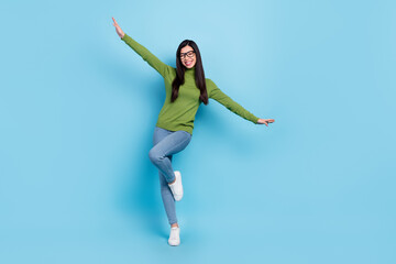 Full length body size view of attractive cheerful funky girl dancing having fun rest isolated over bright blue color background