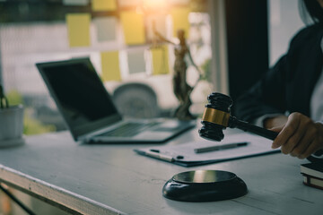 Lawyer's Office Scales of the Goddess of Justice Lawbook and lawyer page. Law concept. Judge's hammer, old courtroom library. Wooden table.