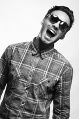 Obraz premium emotional portrait of a young attractive man of athletic build in sunglasses