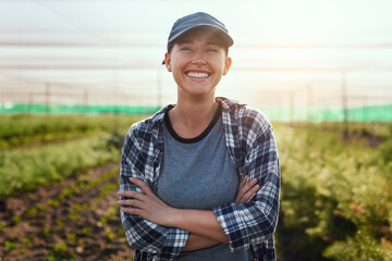 The farm life is the life for me. Cropped portrait of an attractive young female farmer standing...