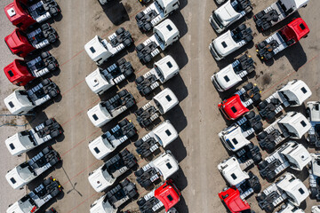 Many trucks on parking lot aerial view, top down perspective