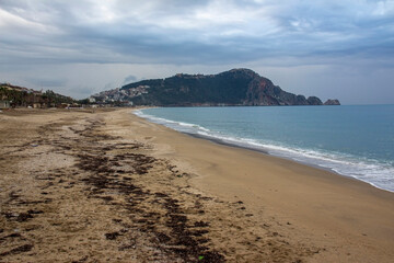 Beach cloudy day in Alanya city, mountain sky and beach