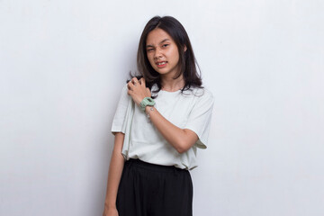 Close up asian beautiful young woman having pain in injured elbow on white background
