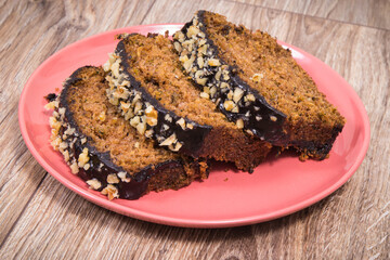 Pastry made of zucchini with nuts and raisin on wooden board. Delicious dessert