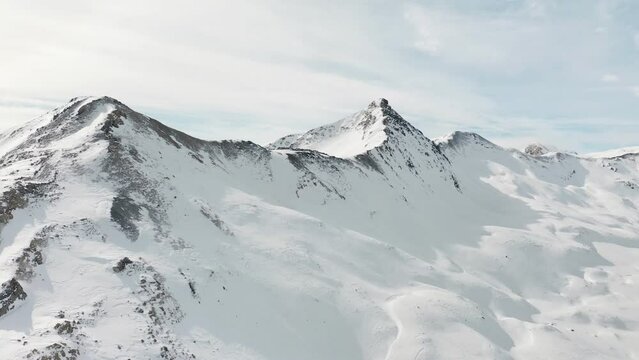 Snow mountain range landscape on winter sunny day. Beautiful panorama of European Alps video from drone. 4k aerial footage of panoramic view of snowy mountains at alpine ski resort in Livigno, Italy 