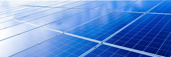 Photovoltaic roof with reflection of the Sun and clouds on the surface.