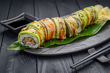 Sushi roll dragon with smoked eel and avocado.