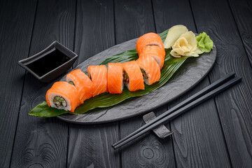 Sushi roll dragon with smoked eel and salmon.