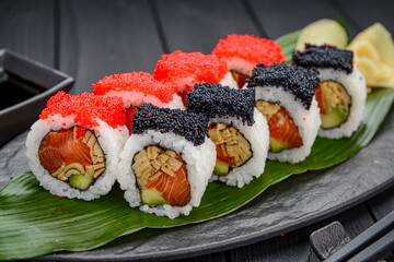 Sushi roll with salmon, scrambled eggs, tobiko caviar.