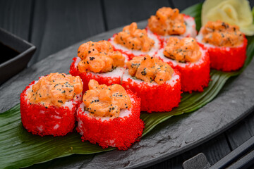Sushi rolls with salmon tempura and tobiko caviar