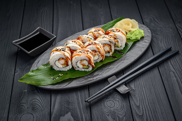 Sushi roll dragon with smoked eel and shrimp.