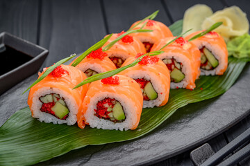Sushi California rolls with salmon and red tobiko caviar
