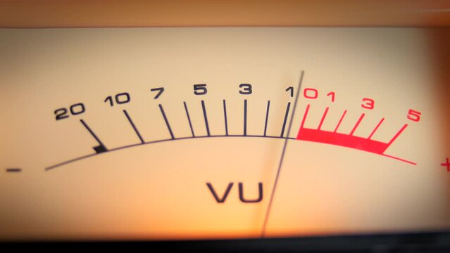 Close up shot of an analog VU audio meter with a moving pin, to your beat. A symbol of music production and recording