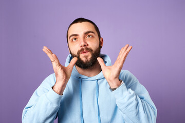Fototapeta premium funny bearded man wears blue sweater on violet background