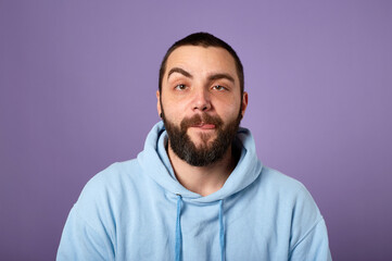 Obraz premium funny bearded man wears blue sweater on violet background