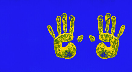 The concept of stop the war! yellow handprints on a blue background, no people, horizontal,