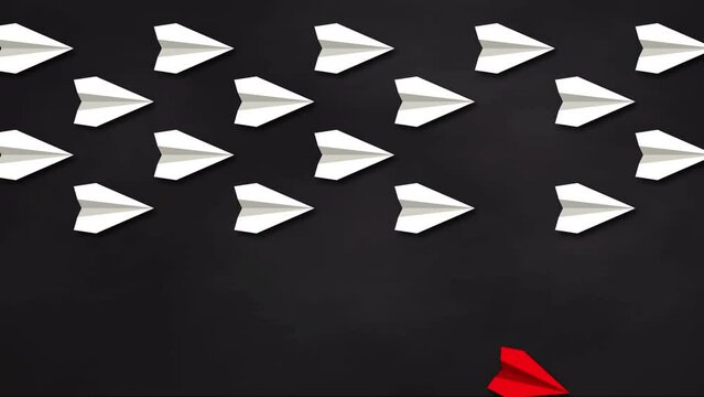 Think differently concept. Red paper plane changes direction. Blackboard background. 