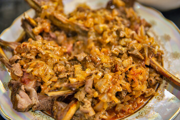 Plate of baked mutton with onions