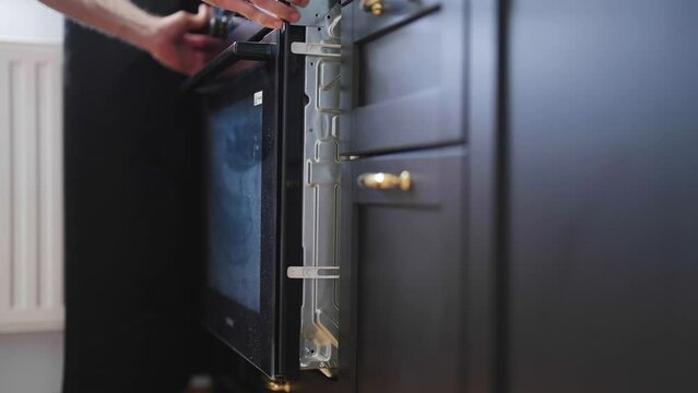 Electrician mount oven in to kitchen black cabinet 4K
