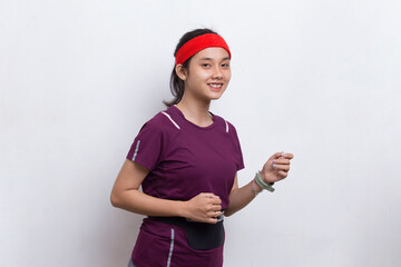 young beautiful asian sporty woman running on white background
