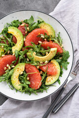Citrus salad with grapefruit, arugula and avocado. Light vegetarian salad