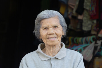 Portrait of old elderly Asian Thai woman smiling. People lifestyle. Senior grandmother.