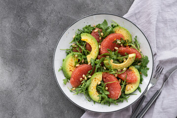 Citrus salad with grapefruit, arugula and avocado. Light vegetarian salad