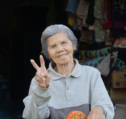 Portrait of old elderly Asian Thai woman smiling. People lifestyle. Senior grandmother.