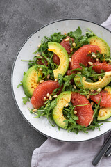 Citrus salad with grapefruit, arugula and avocado. Light vegetarian salad