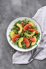 Citrus salad with grapefruit, arugula and avocado. Light vegetarian salad