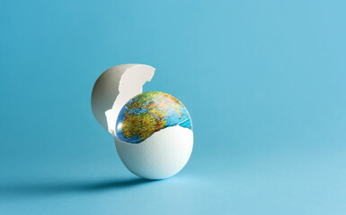 The globe hatches from the egg. The birth of the earth.