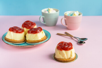 Bavarian cream pastry with strawberry jelly, two cups and rose