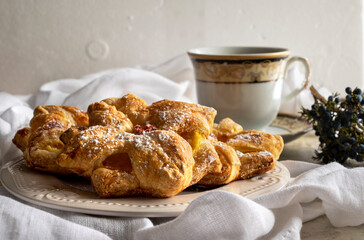 Delicious baked puff pastry with toppings and cup of tee