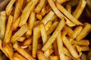 Crispy French fries background closes up image.