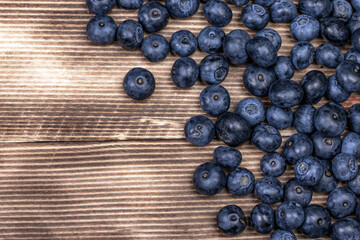 Blueberry background. Ripe blueberry on wooden background.