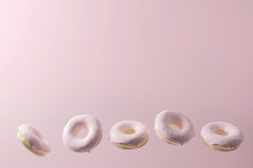 3d render of donut border with pastel pink glaze on a pink background