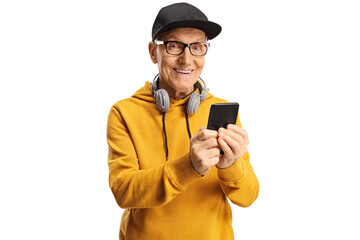 Elderly man with headphones around neck and a cap holding a smartphone