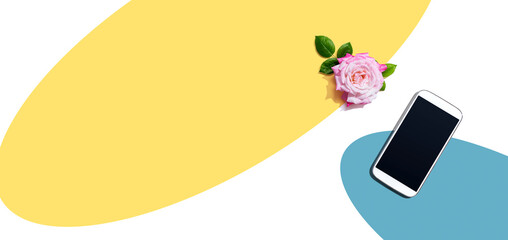 Smartphone with a pink rose - flat lay