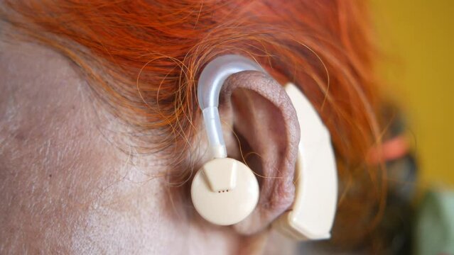 Hearing aid concept, a senior women with hearing problems.