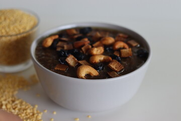 Sweet Pongal. An Indian sweet dish made of white rice and yellow moong lentils and jaggery. Garnished with ghee fried cashews nuts and coconut bits